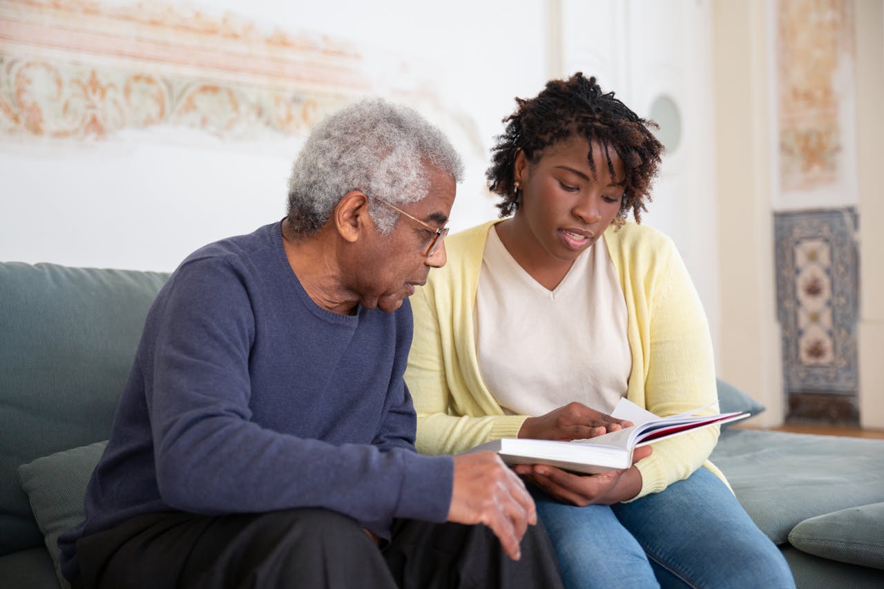 A resident and staff member reading together