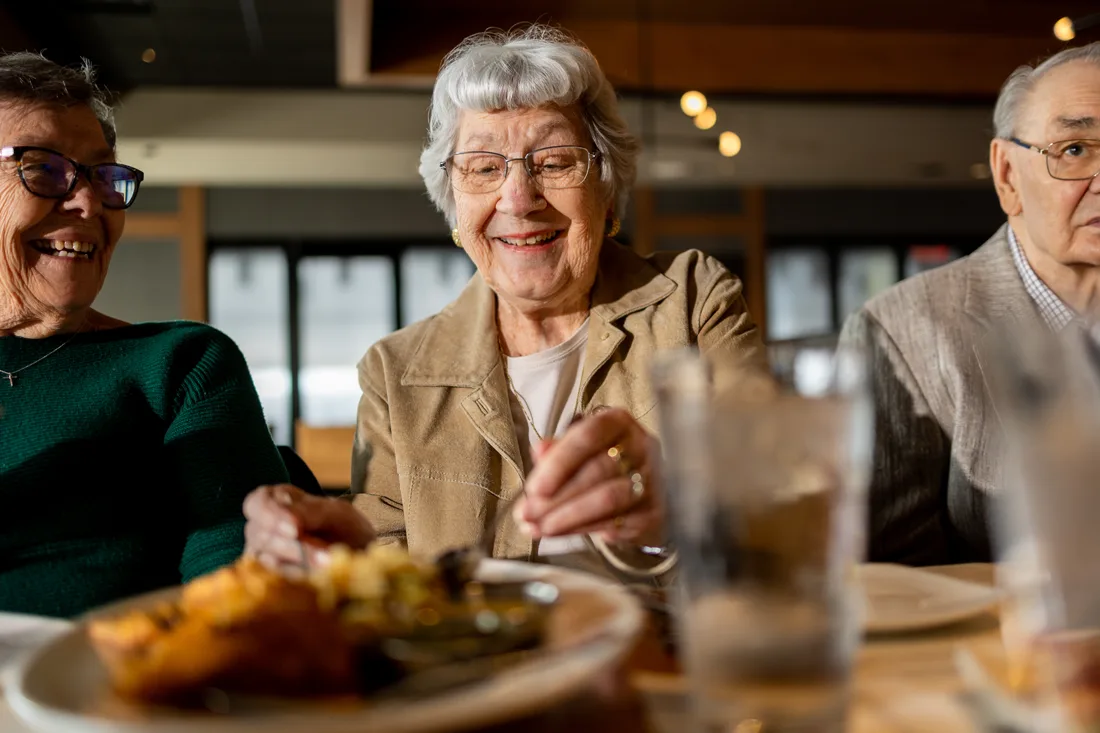 Residents enjoying a meal together in the dining area