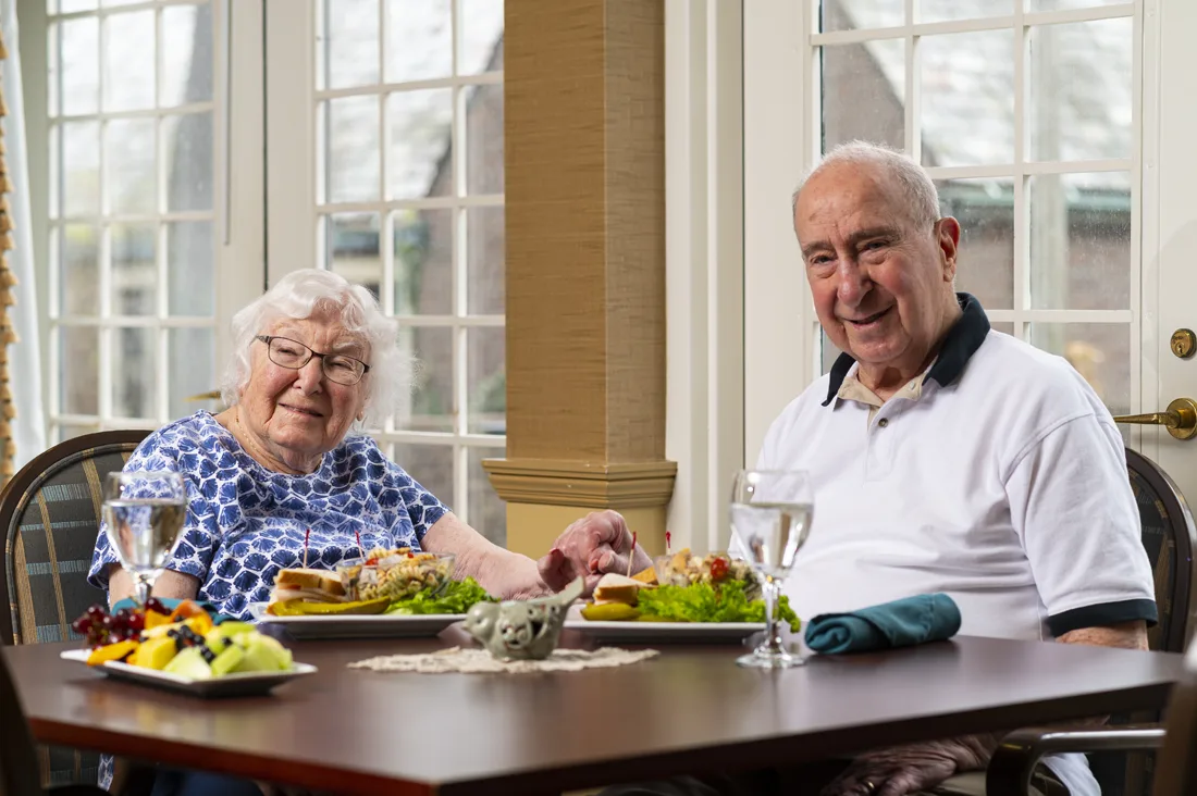 Two residents enjoying a meal together at a table