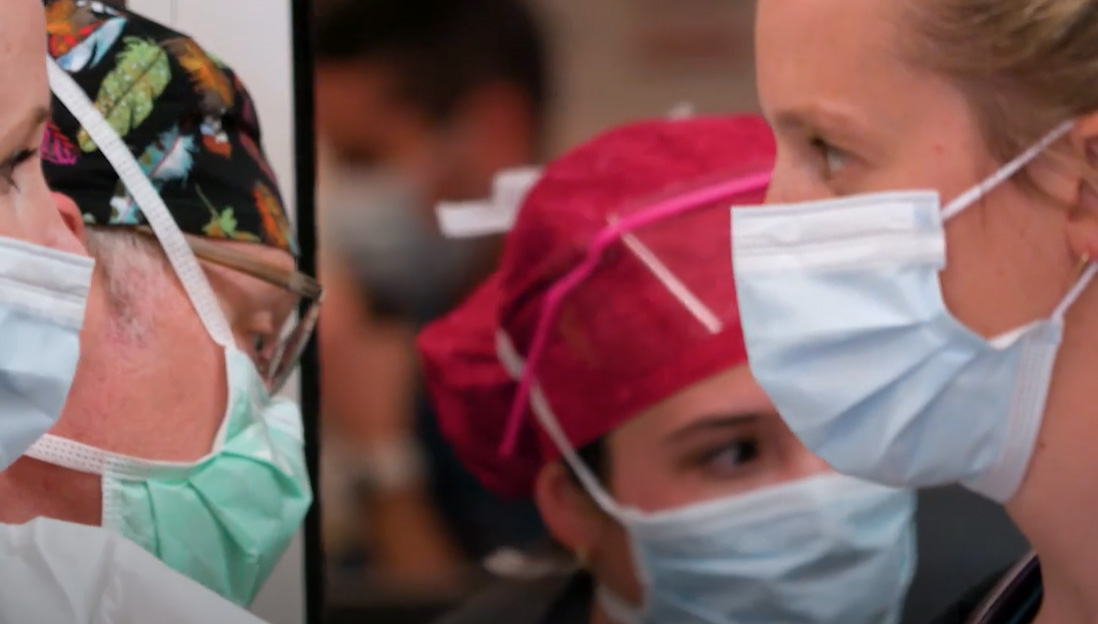 Healthcare workers in masks and scrubs in a facility
