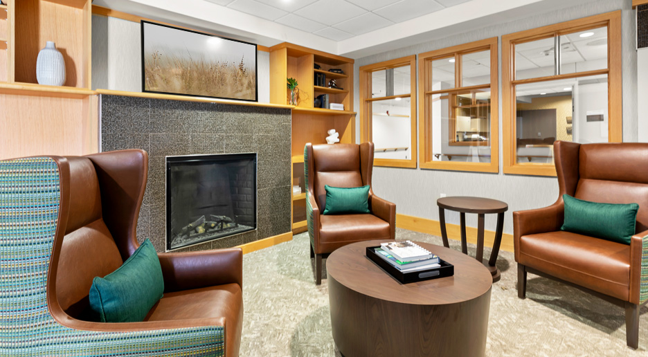 Cozy common area with armchairs and fireplace
