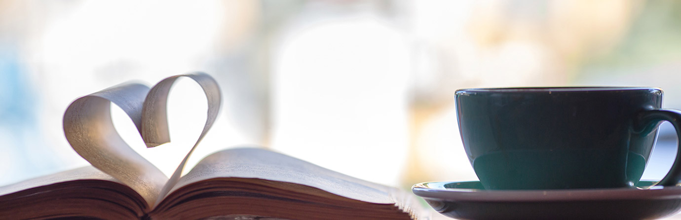 Book with heart-shaped page and coffee cup