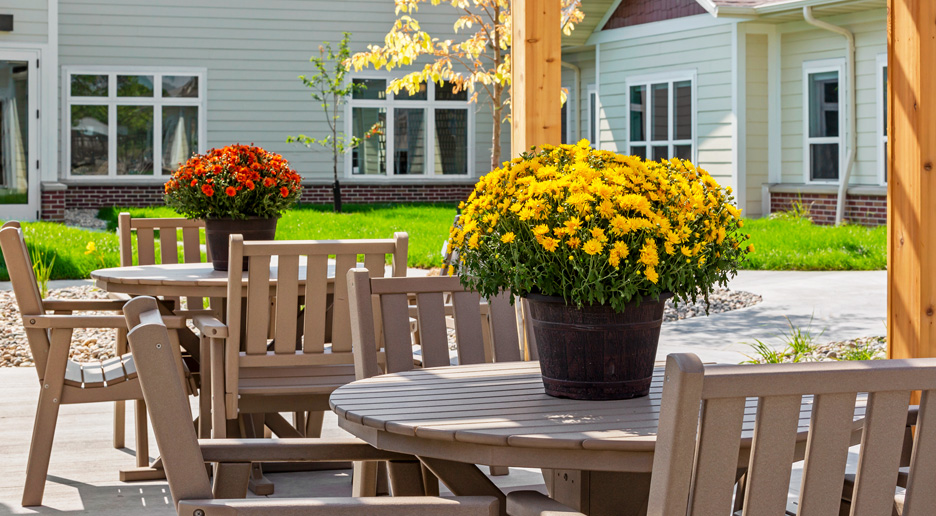 Outdoor seating area with potted flowers