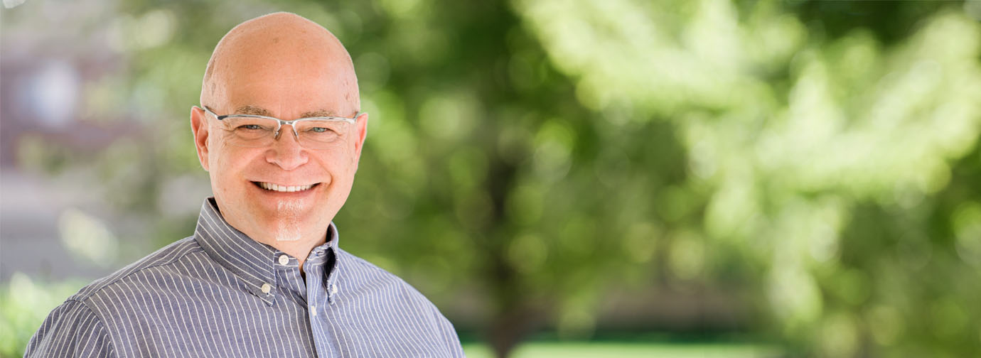 Smiling resident outdoors in a green space