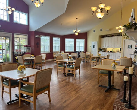 Bright dining room with tables and chairs set up