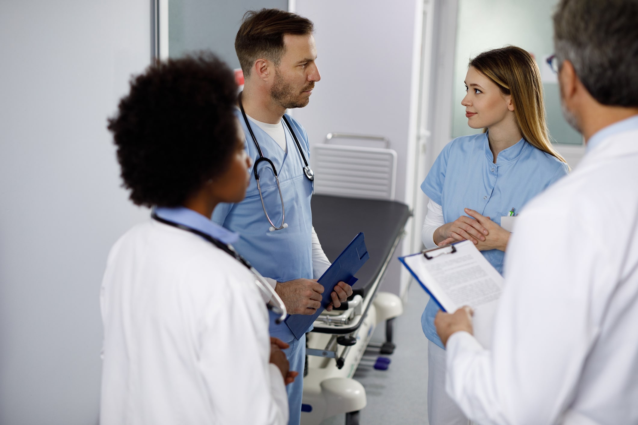 Medical staff discussing patient care in a treatment room