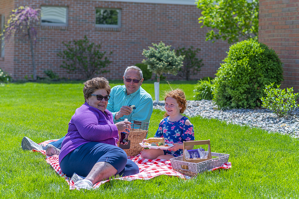Residents enjoying a picnic on the green lawn