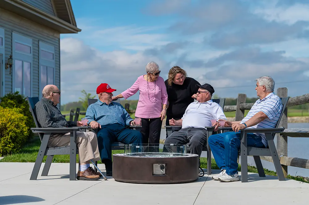 Residents enjoying time together by a fire pit