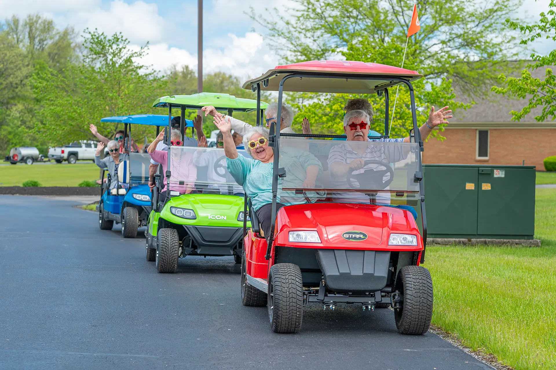Residents enjoying a golf cart parade in the community