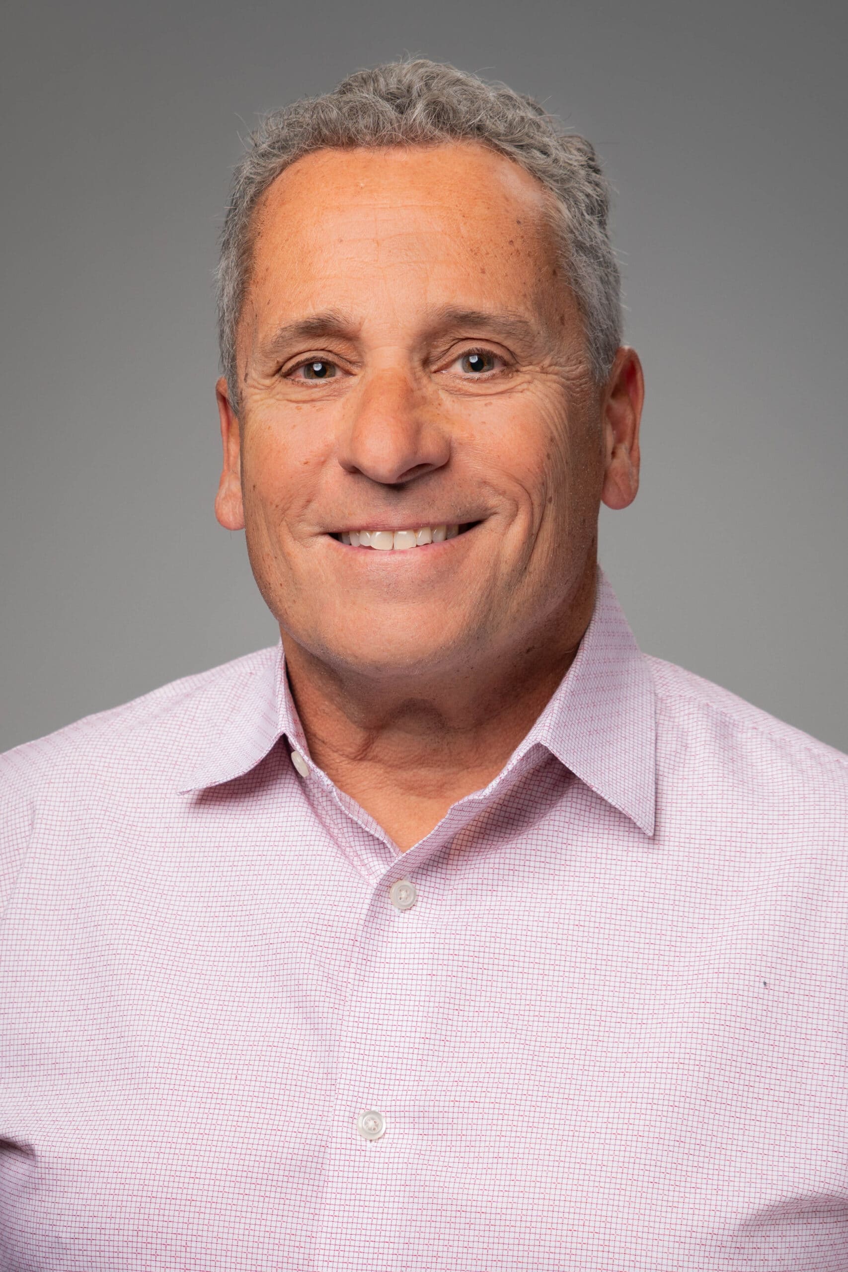 Portrait of a man smiling in a collared shirt