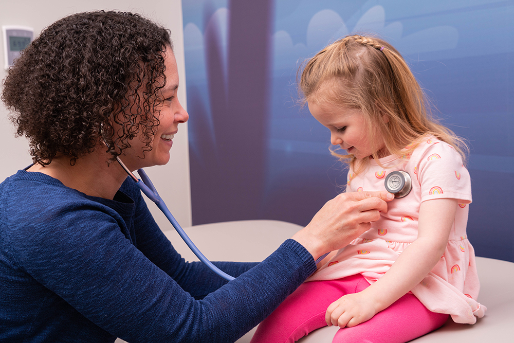 A healthcare professional examining a young child