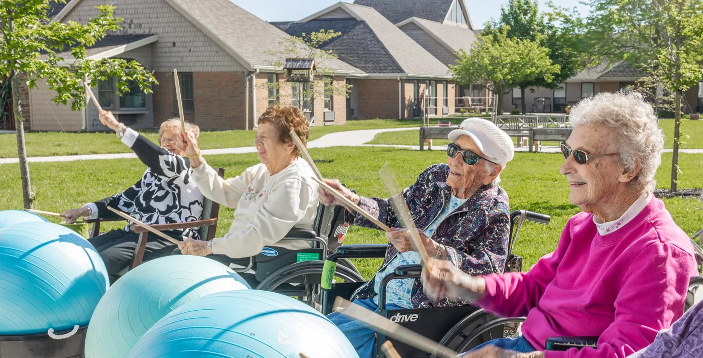 Residents enjoying an outdoor drumming activity