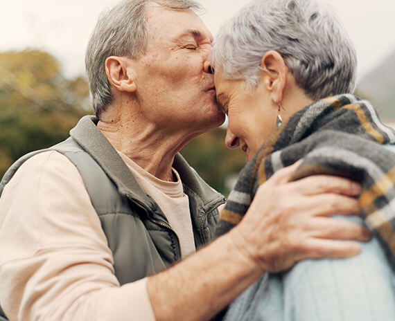 Couple sharing a warm moment outdoors