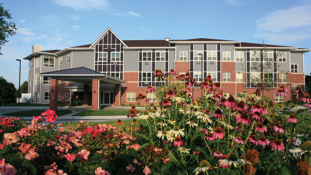 Exterior view of the facility with landscaped flowers