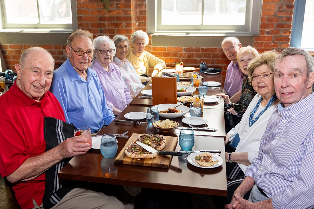 Residents enjoying a meal together at a dining table