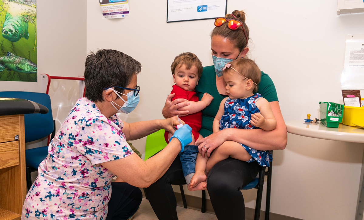 Healthcare professional administering a vaccine to children
