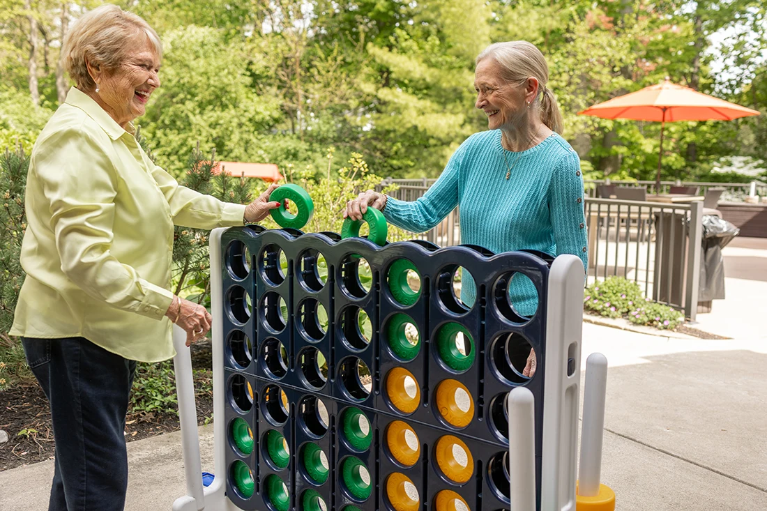 Two residents playing a large outdoor game together