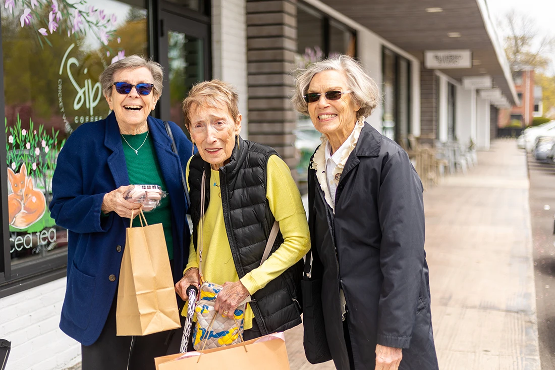 Three residents enjoying a day out in a friendly community