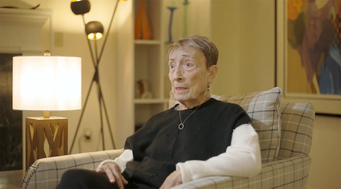 Senior resident sitting in a well-lit common area