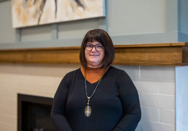 Staff member in a cozy lobby setting