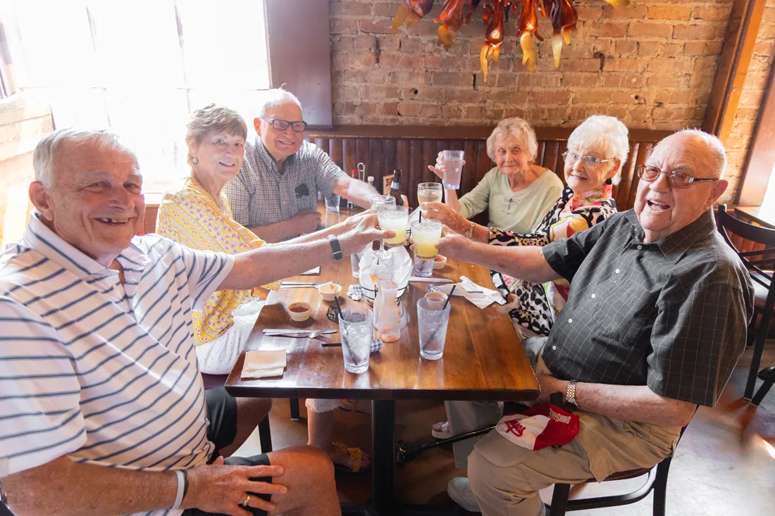 Residents enjoying a meal together at a dining table
