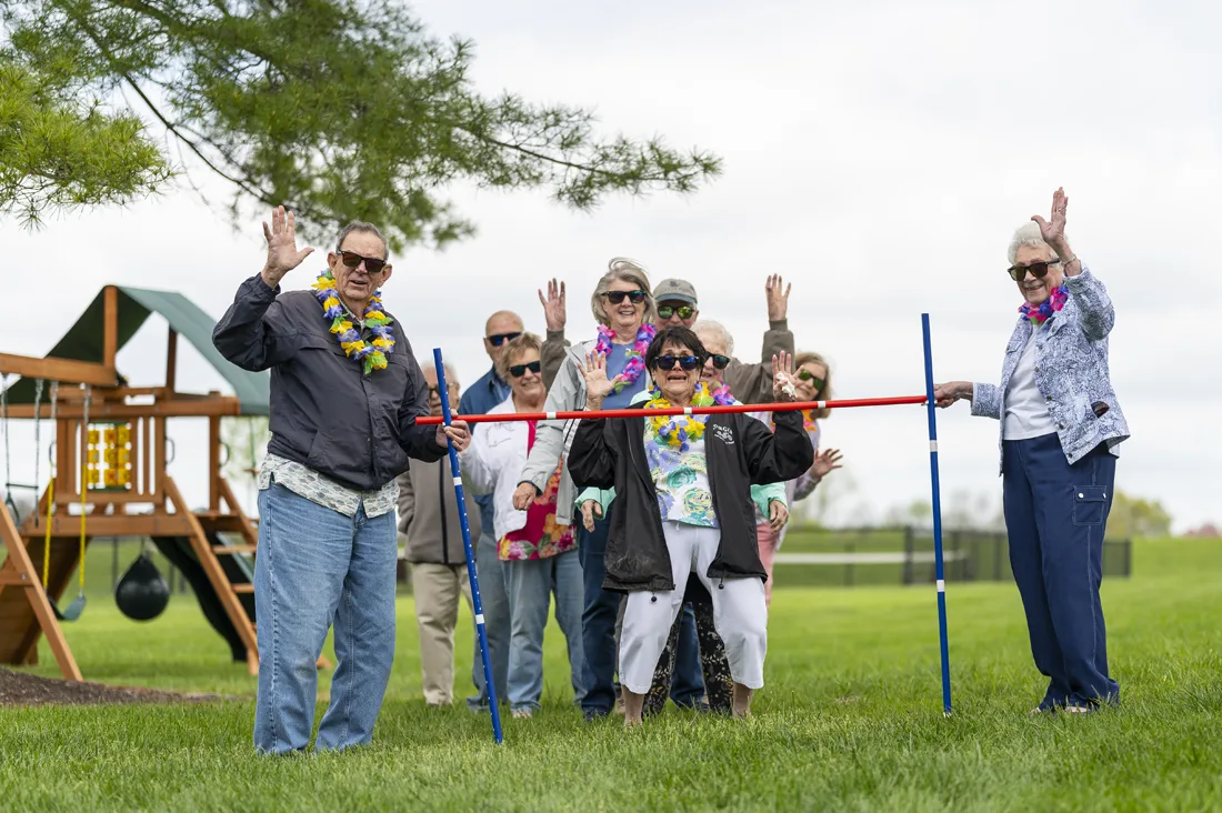 Residents celebrating outdoors with leis in a fun activity