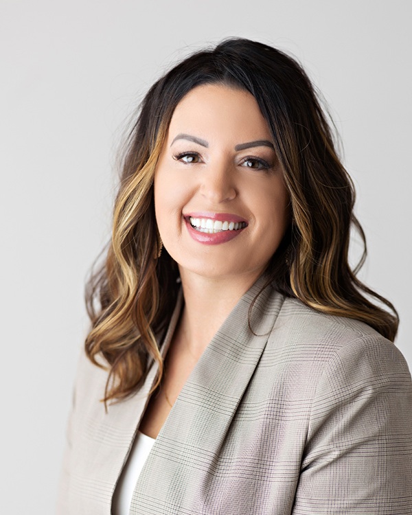 A smiling woman's portrait in a professional setting