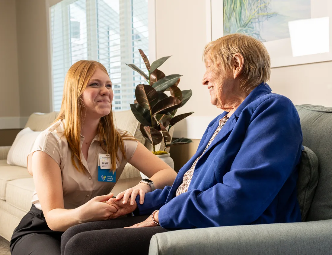 Caregiver interacting with a resident in a common area