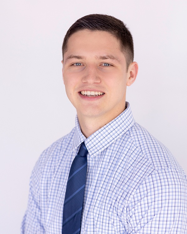 Young man in a professional attire smiling