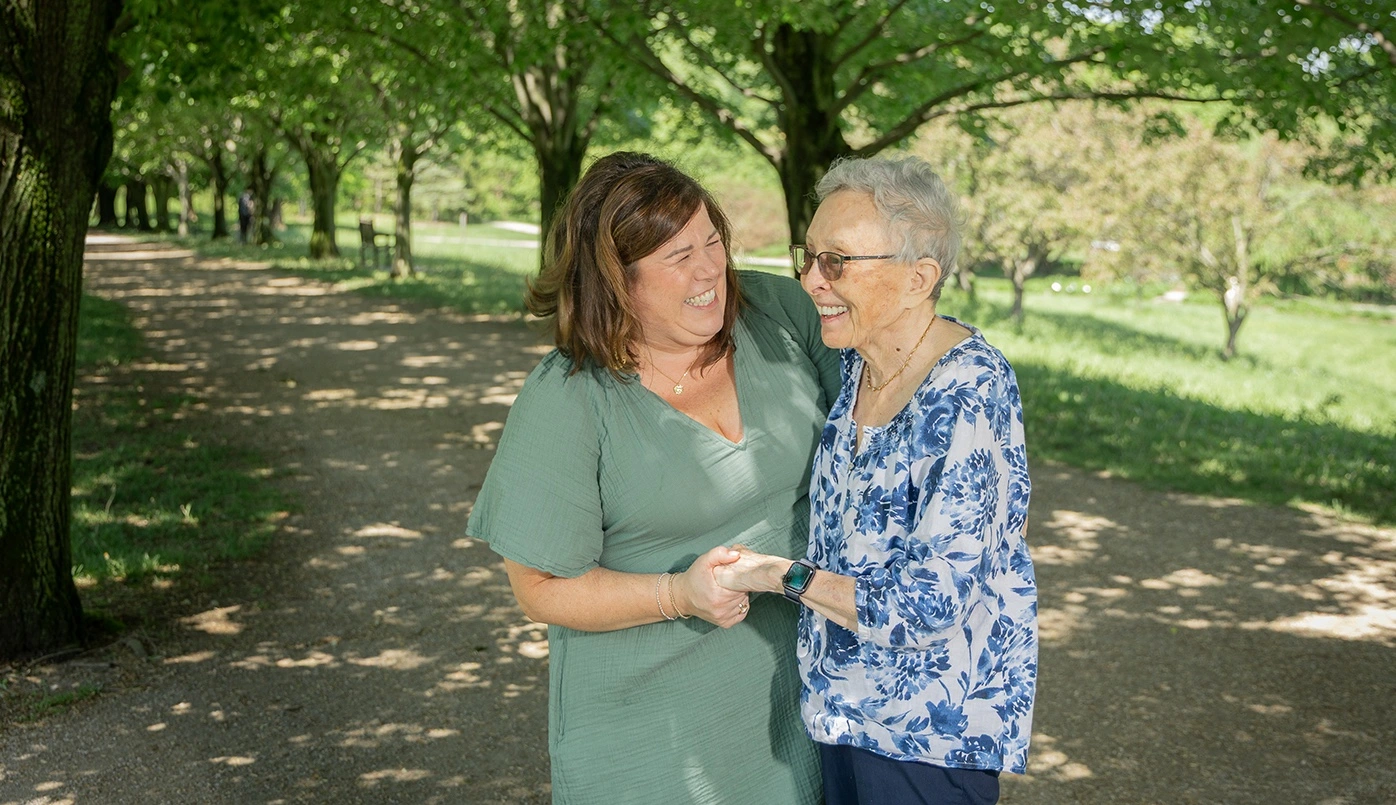 Two women sharing a joyful moment outdoors