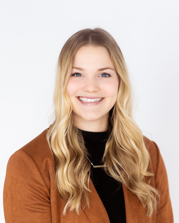 Smiling young woman in a brown blazer