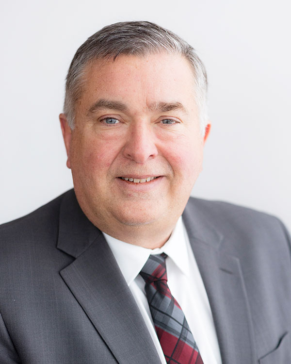 Professional portrait of an older man in a suit