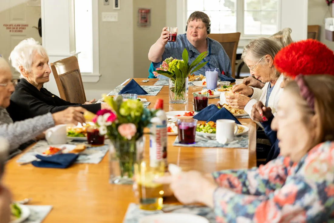 Residents enjoying a meal together in a dining room