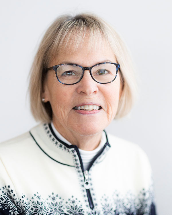 Smiling elderly woman wearing a festive sweater