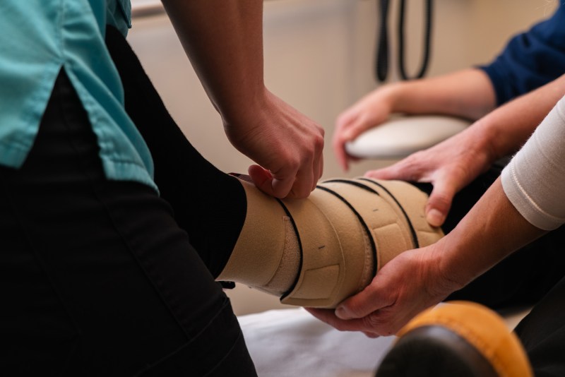 Therapist assisting a resident with leg rehabilitation
