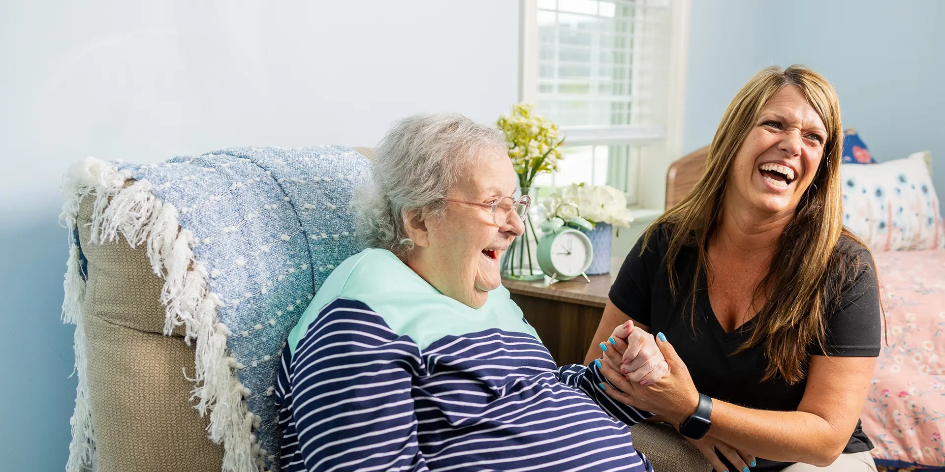 Resident and staff enjoying a joyful moment together