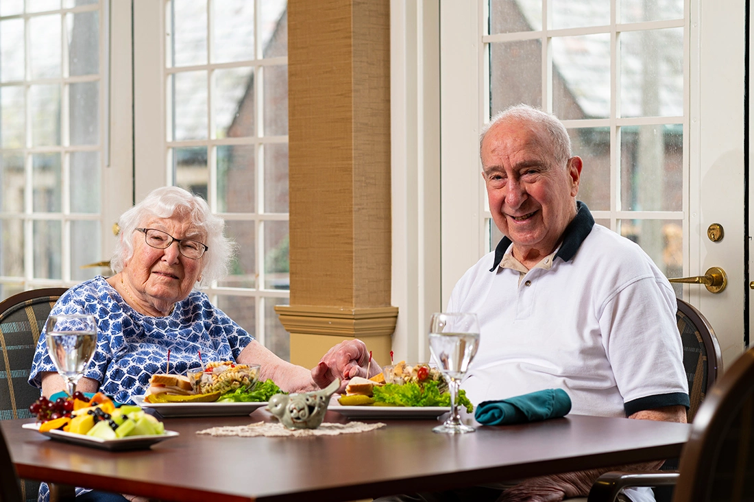 Residents enjoying a meal together in the dining room
