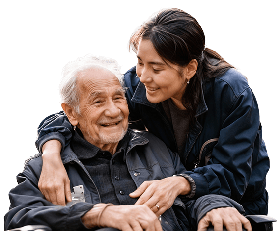 Senior man smiling with a caregiver on his wheelchair
