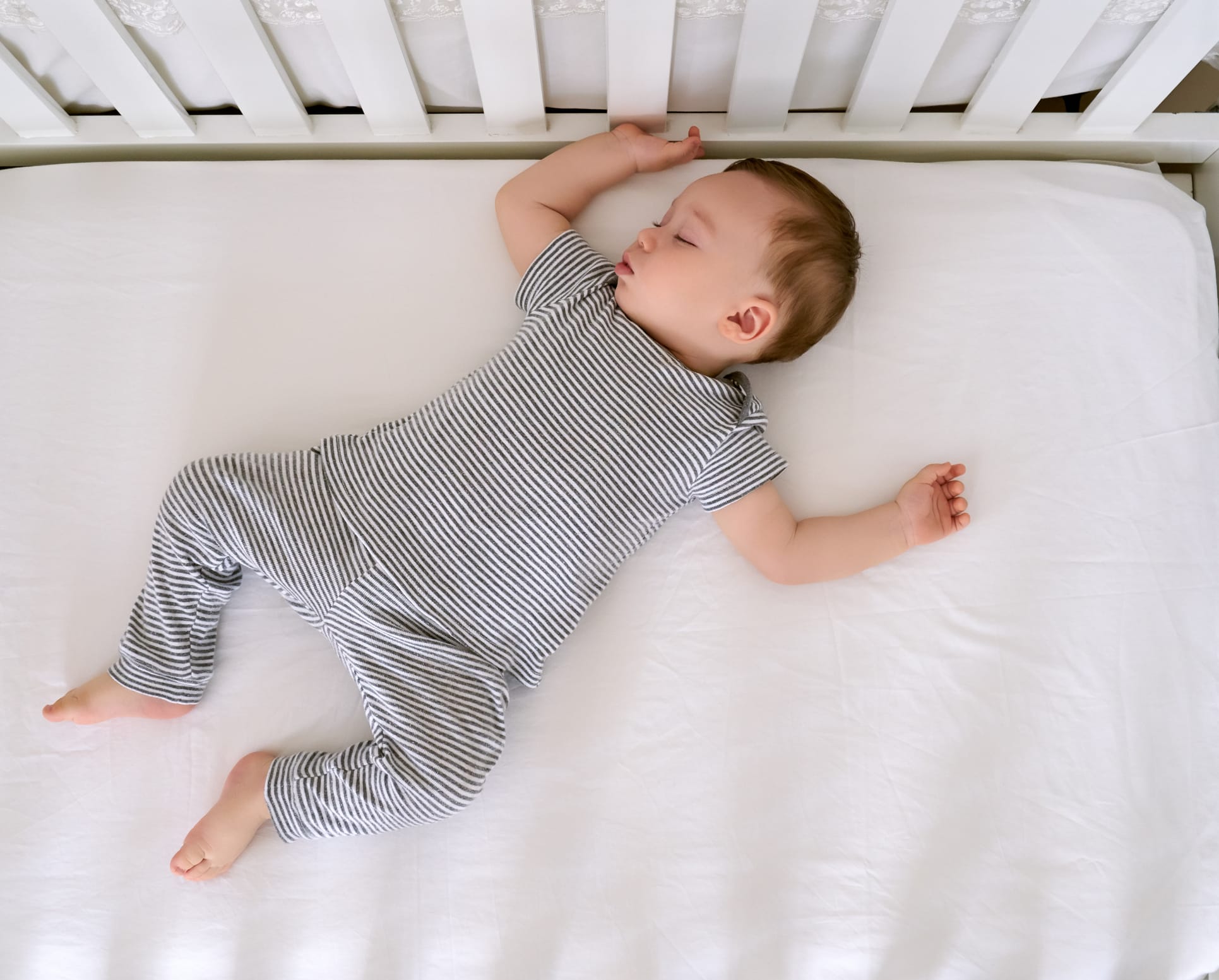 A baby sleeping peacefully in a crib