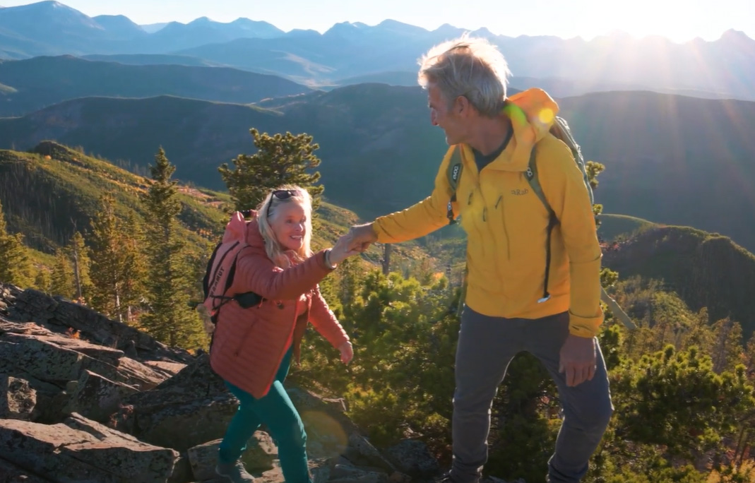 Two people hiking in a mountainous landscape