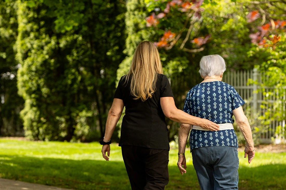 Staff member assisting a resident outdoors