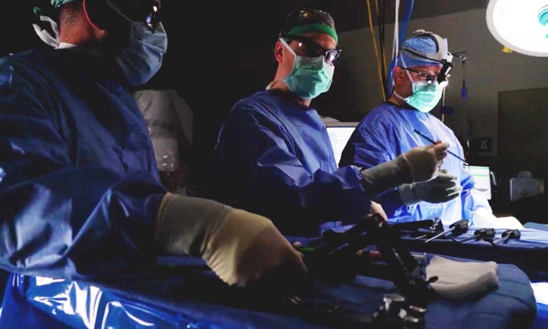 Medical staff in surgical attire during a procedure
