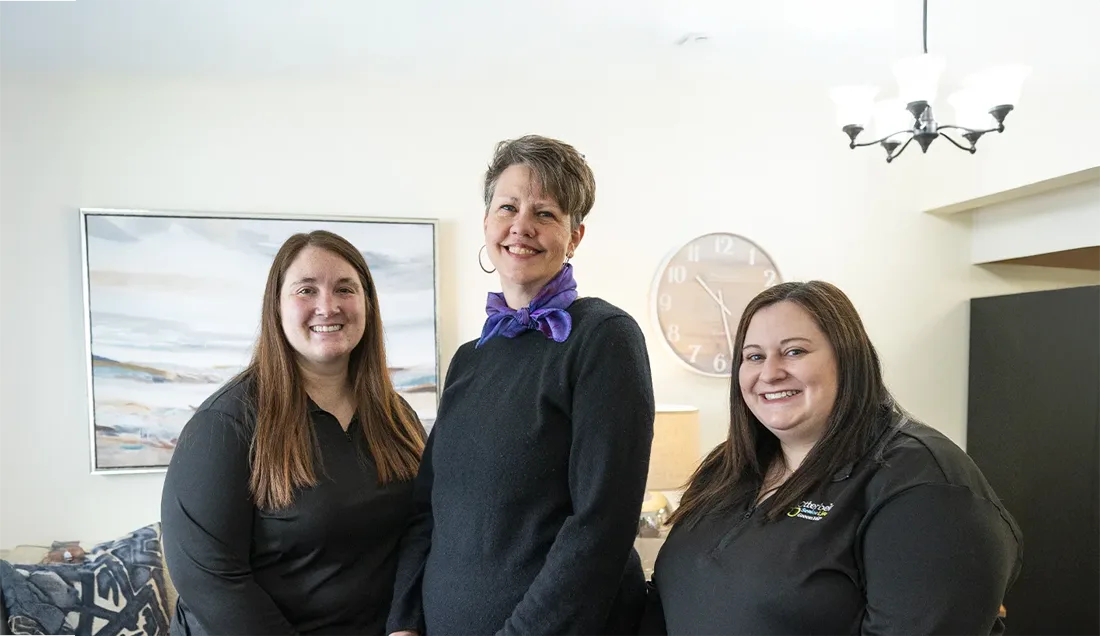 Staff members posing in a well-lit common area