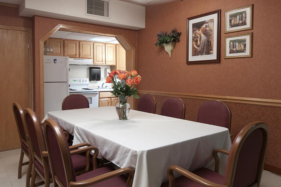 A dining area with a table and flowers