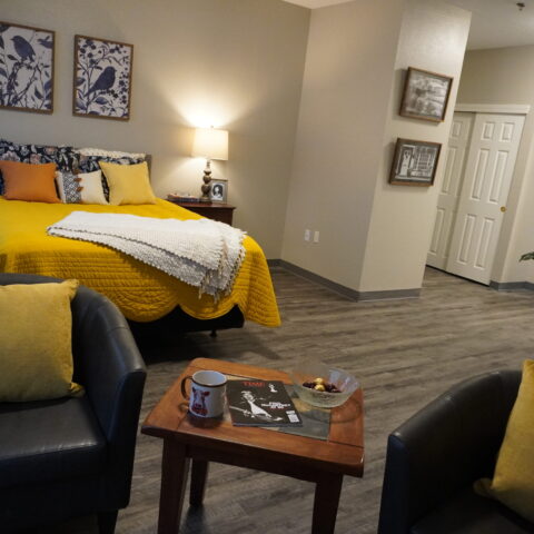 Cozy resident room with yellow bedding and modern decor.