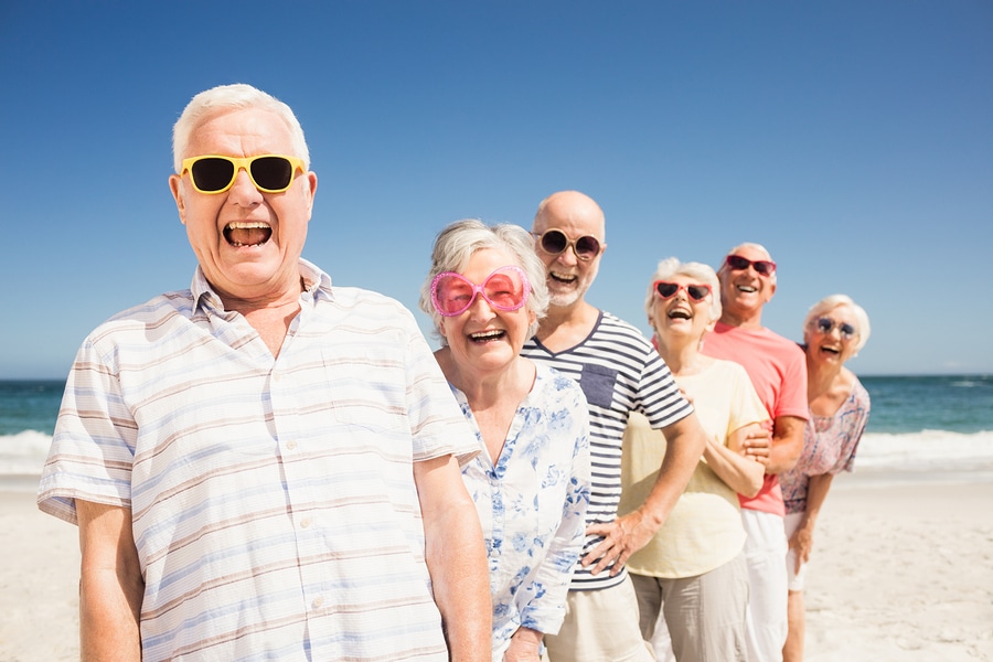 Seniors happily enjoying a beach day