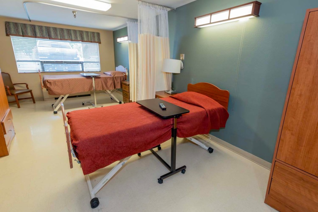 An interior view of a resident room with beds.