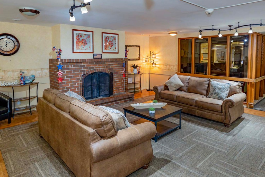 Cozy common area with sofas and a fireplace.