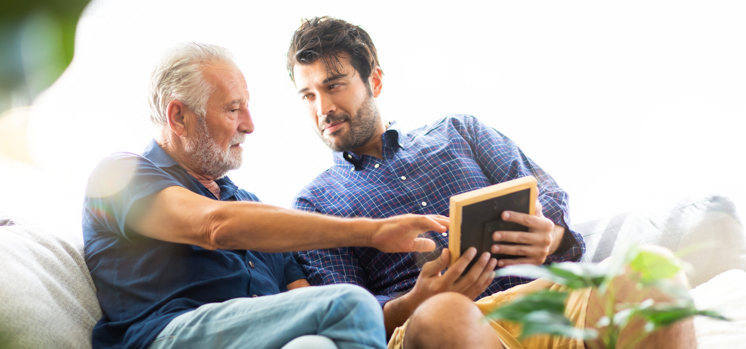 A senior man and a younger man engaging in conversation.