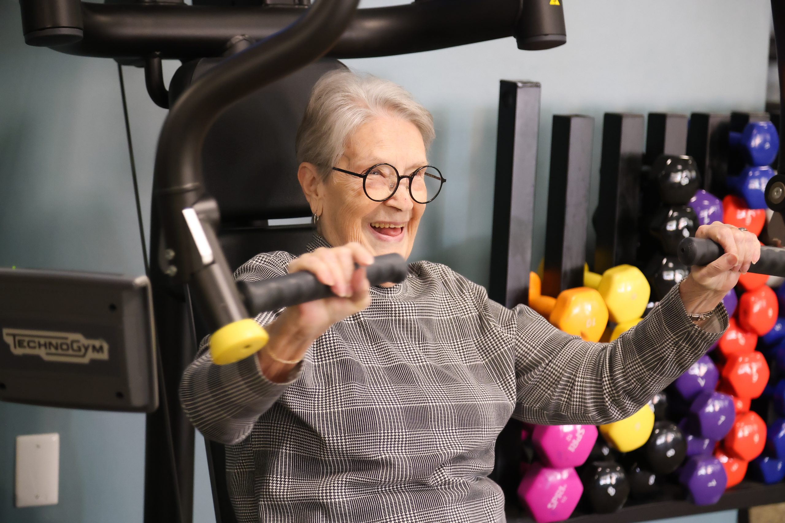 Senior resident exercising with gym equipment